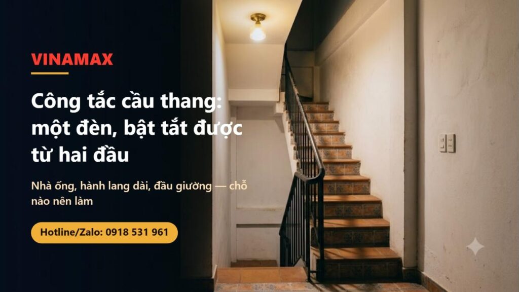 Cầu thang nhà ống với bậc gạch bông, tay vịn sắt, đèn trần và bộ công tắc trắng gắn trên tường
